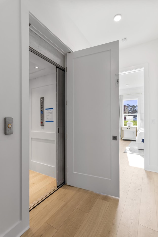 hallway featuring light wood finished floors