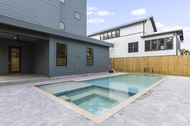 view of swimming pool featuring an in ground hot tub, a patio area, and fence