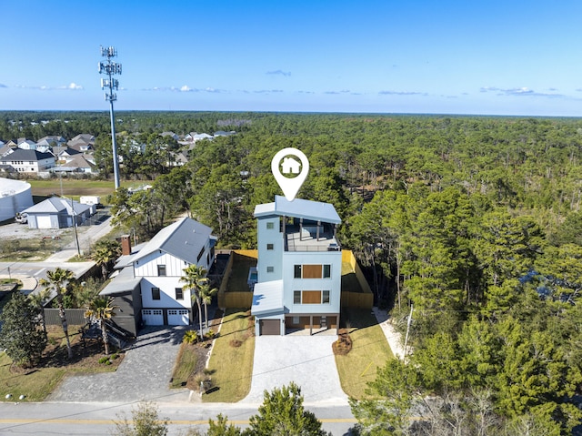 birds eye view of property featuring a wooded view