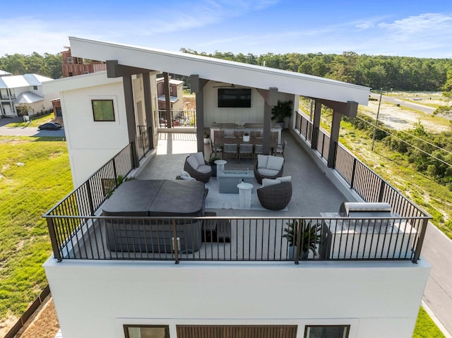 back of property with a balcony and outdoor dining area