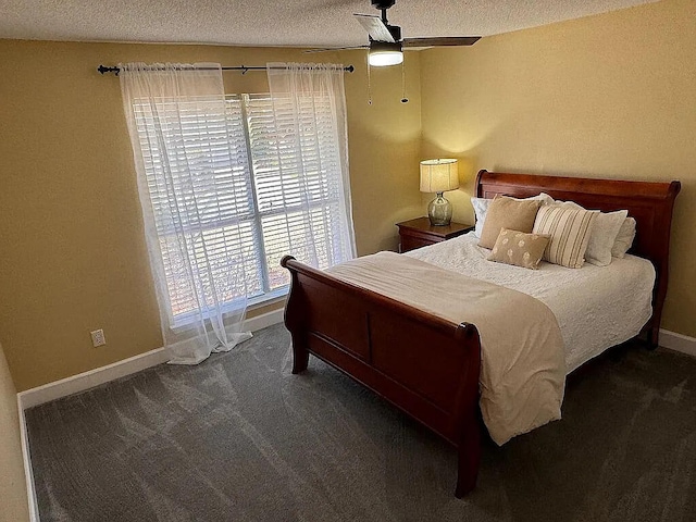 carpeted bedroom featuring baseboards, a textured ceiling, and ceiling fan