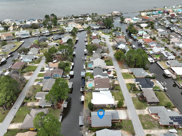 drone / aerial view featuring a residential view and a water view