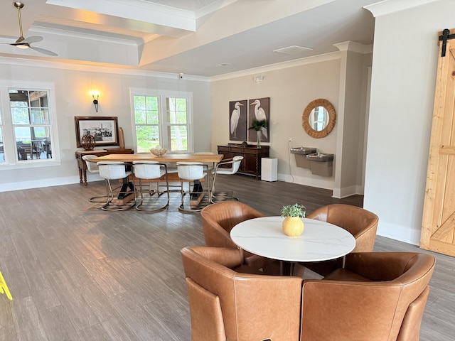379 Whitman Way, Freeport, FL 32439 - dining space featuring ornamental molding, a ceiling fan, beam ceiling, a barn door, and wood finished floors