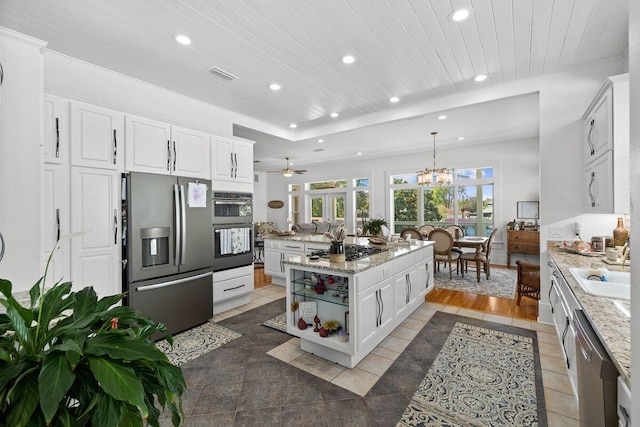 4077 N Indian Byu, Destin, FL 32541 - kitchen with appliances with stainless steel finishes, recessed lighting, wooden ceiling, white cabinets, and an island with sink