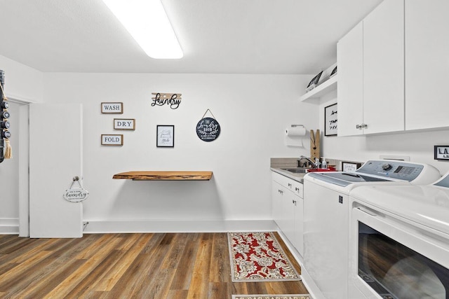 4077 N Indian Byu, Destin, FL 32541 - laundry area featuring cabinet space, independent washer and dryer, wood finished floors, and baseboards