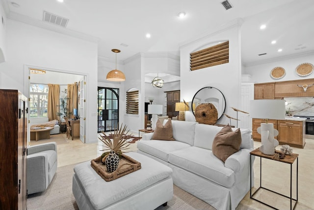 living room with recessed lighting, visible vents, and crown molding