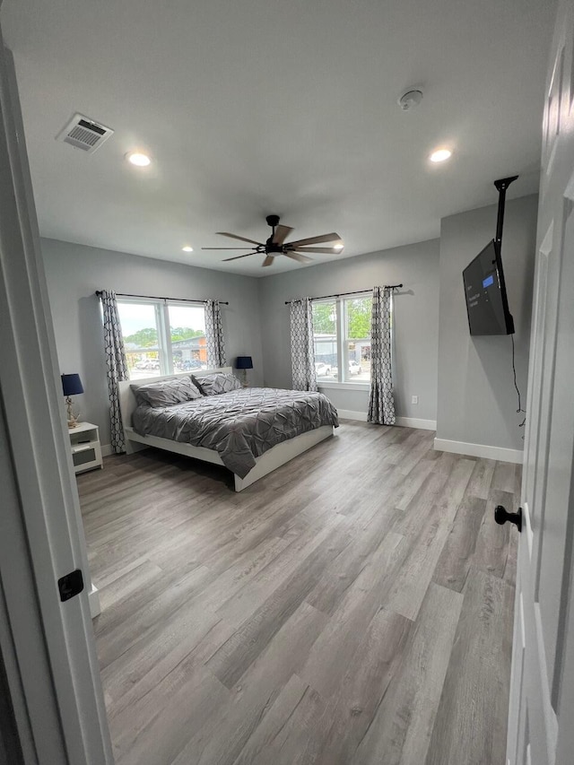 unfurnished bedroom featuring light wood-style flooring, recessed lighting, baseboards, and visible vents