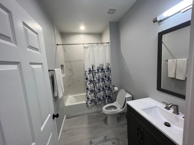 bathroom with visible vents, toilet, wood finished floors, shower / bath combination with curtain, and vanity