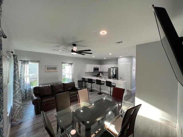 dining space with a ceiling fan, recessed lighting, wood finished floors, and visible vents