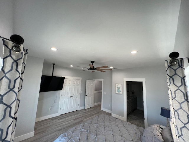 unfurnished bedroom featuring a closet, recessed lighting, baseboards, and wood finished floors