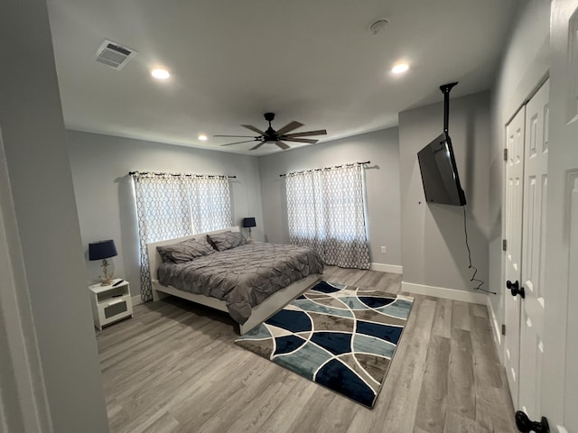 bedroom featuring recessed lighting, wood finished floors, visible vents, and baseboards