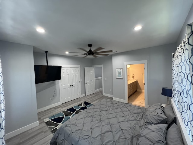 bedroom featuring recessed lighting, a closet, baseboards, and wood finished floors