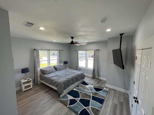 bedroom featuring recessed lighting, visible vents, baseboards, and wood finished floors