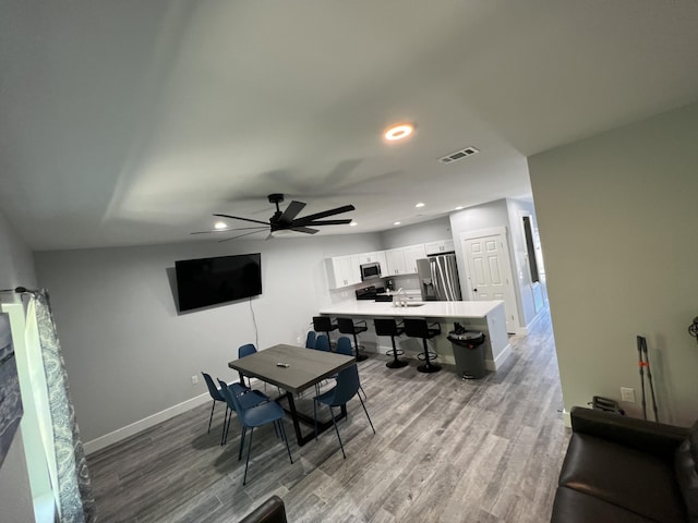 dining room with visible vents, recessed lighting, baseboards, and wood finished floors