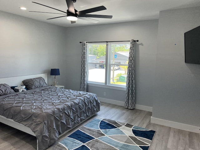 bedroom featuring a ceiling fan, recessed lighting, wood finished floors, and baseboards