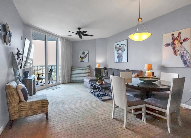 dining space with floor to ceiling windows and ceiling fan