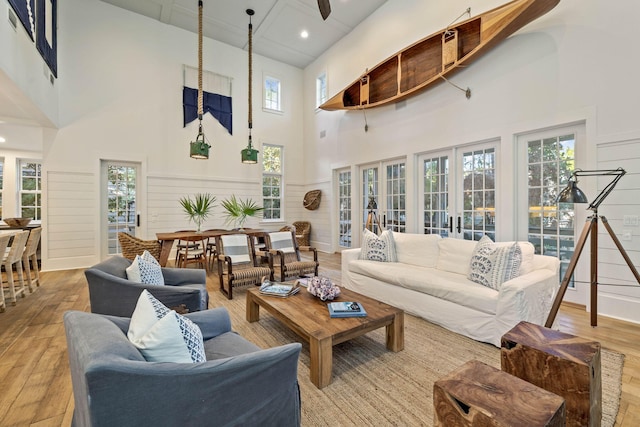 living room with hardwood / wood-style flooring, french doors, and a healthy amount of sunlight