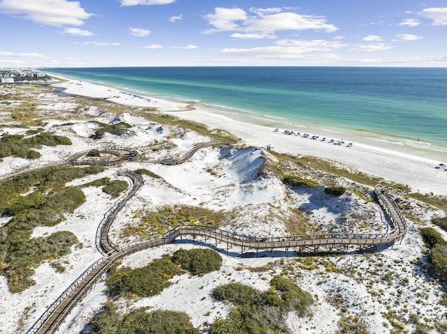 aerial view with a water view and a view of the beach