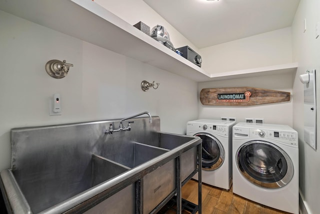 clothes washing area featuring wood finished floors, laundry area, and washing machine and clothes dryer