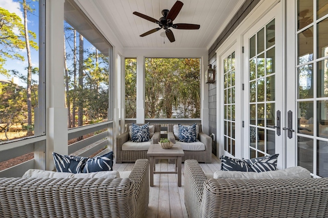 sunroom with wooden ceiling and a ceiling fan