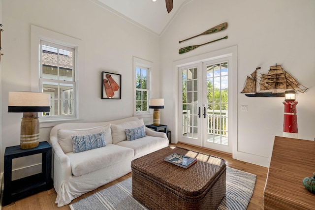 living room with french doors, wood finished floors, a ceiling fan, and vaulted ceiling