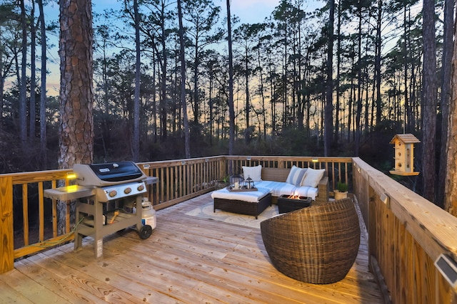 wooden terrace featuring a grill and an outdoor hangout area