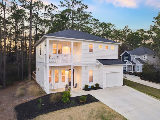 view of front of property featuring a porch, a balcony, driveway, and roof with shingles