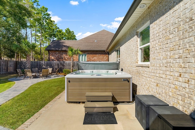 view of patio with a fenced backyard and a hot tub