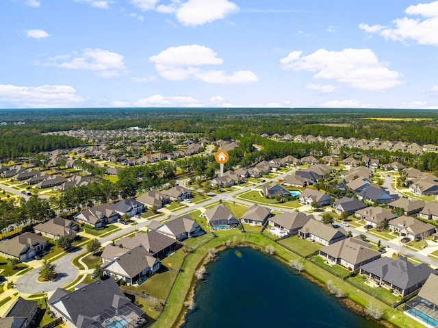 birds eye view of property with a water view and a residential view