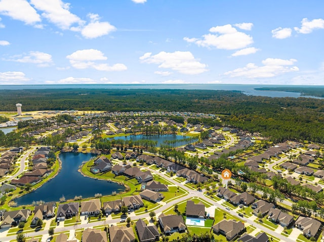 aerial view with a wooded view, a water view, and a residential view