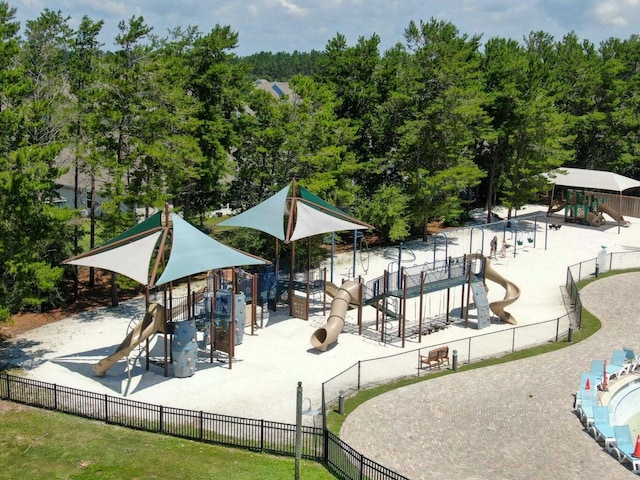 view of community with playground community and fence