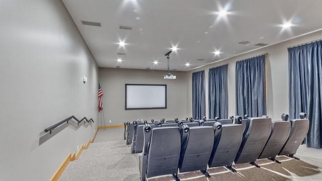 carpeted home theater with visible vents and baseboards