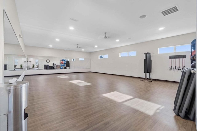 exercise area featuring visible vents, wood finished floors, a wealth of natural light, and recessed lighting