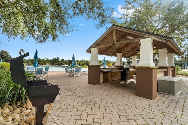 view of patio / terrace featuring a gazebo, outdoor dry bar, and an outdoor pool