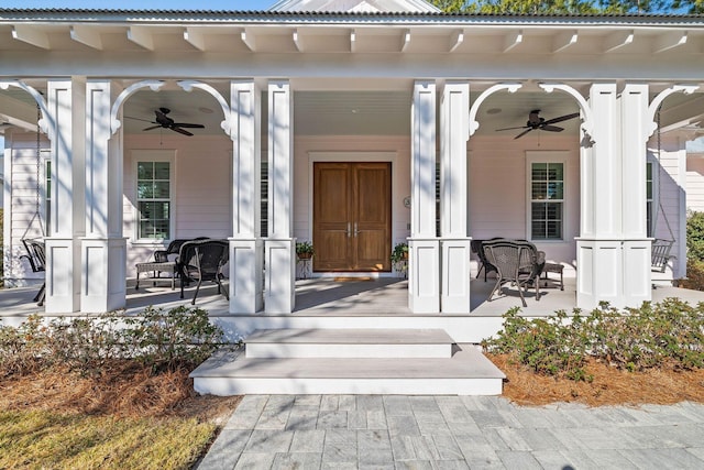 view of exterior entry featuring a ceiling fan and covered porch