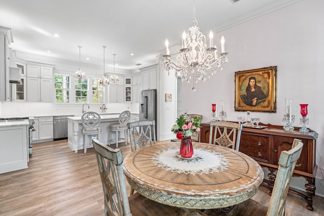 dining space featuring a notable chandelier, recessed lighting, crown molding, and light wood-type flooring