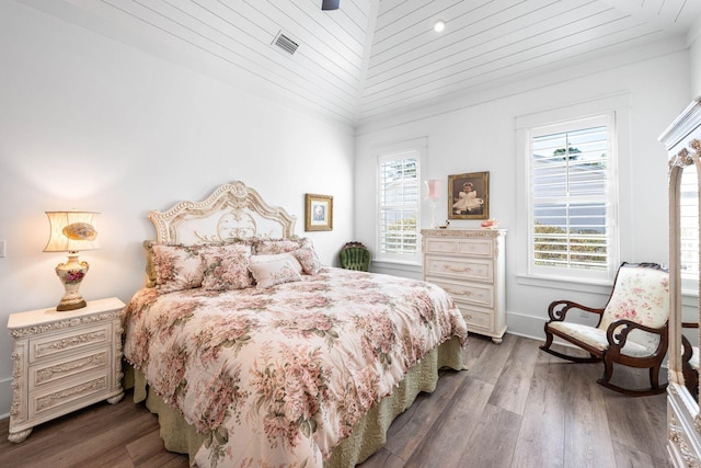 bedroom featuring visible vents, multiple windows, ceiling fan, and wood finished floors