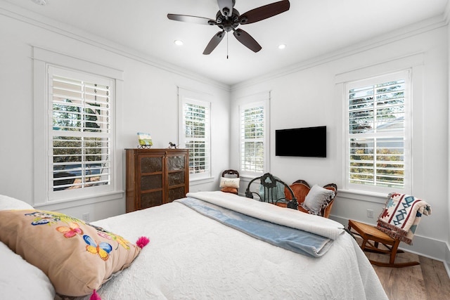 bedroom featuring recessed lighting, ornamental molding, baseboards, and wood finished floors