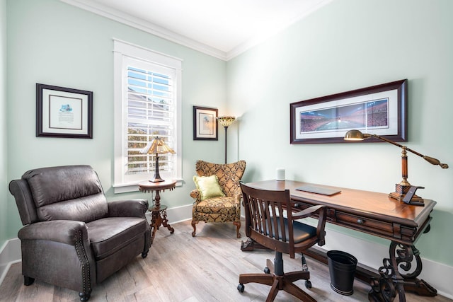 office area featuring wood finished floors, baseboards, and ornamental molding