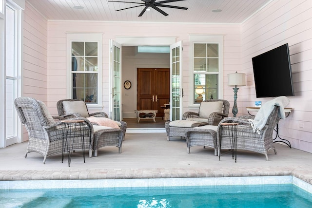 outdoor pool featuring an outdoor living space and ceiling fan