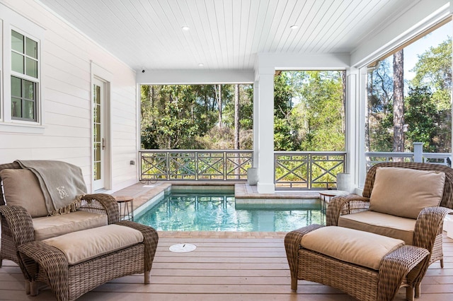 sunroom featuring a swimming pool, wood ceiling, and a wealth of natural light