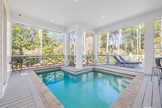 indoor pool featuring a deck