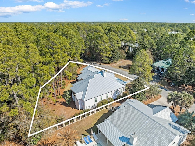 birds eye view of property featuring a wooded view