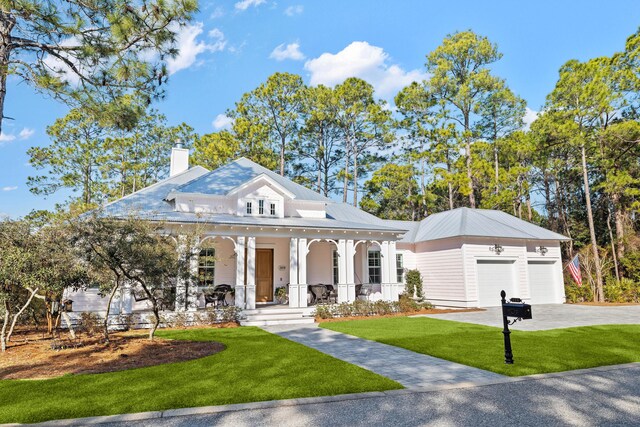 359 Wood Beach Dr, Santa Rosa Beach, FL 32459 - view of front of home featuring covered porch, a front lawn, a chimney, a garage, and driveway