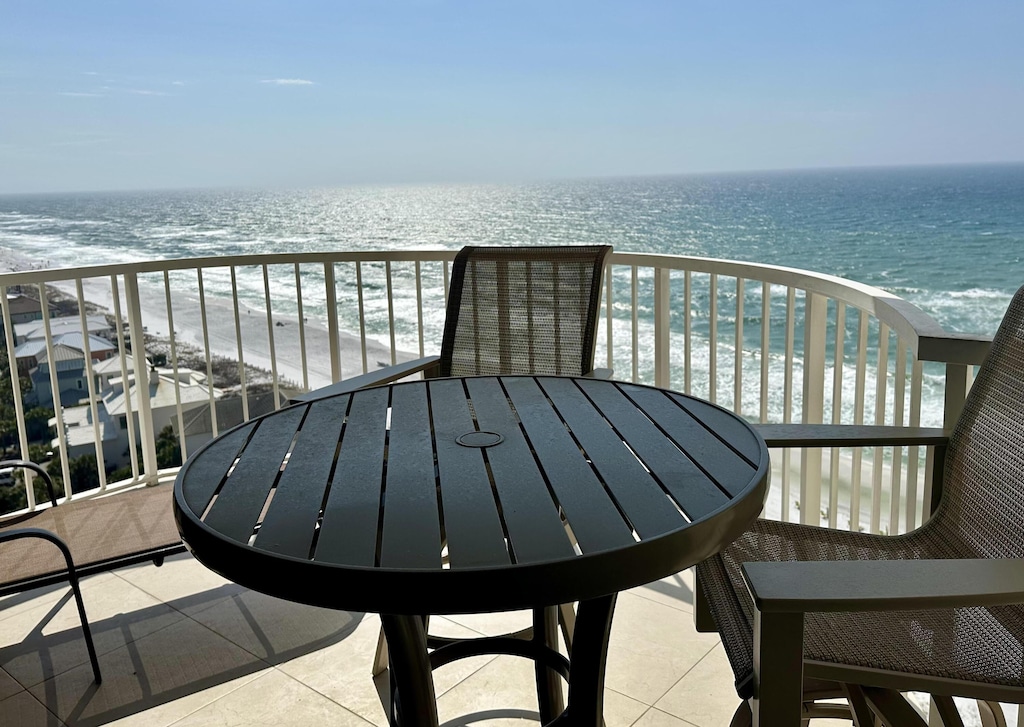 balcony with a view of the beach and a water view