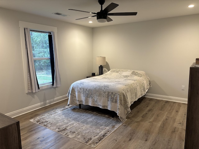 bedroom with visible vents, recessed lighting, baseboards, and wood finished floors