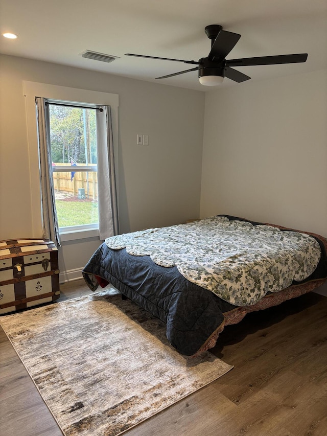 bedroom featuring visible vents, baseboards, ceiling fan, recessed lighting, and wood finished floors