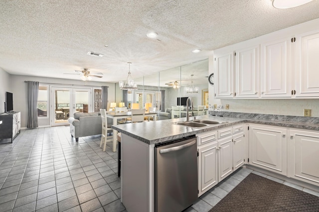 kitchen with visible vents, a sink, stainless steel dishwasher, open floor plan, and a peninsula