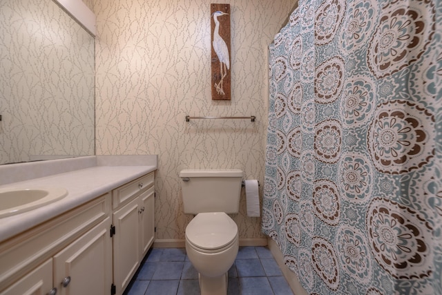 full bathroom featuring vanity, baseboards, wallpapered walls, tile patterned floors, and toilet