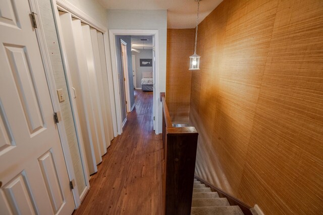 corridor with wood finished floors and stairs